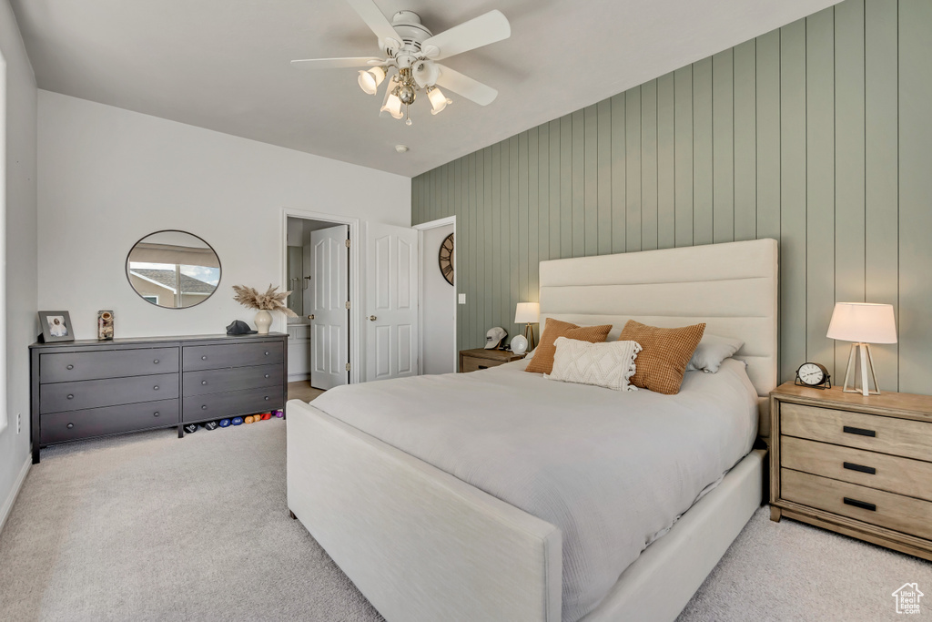 Carpeted bedroom with ceiling fan