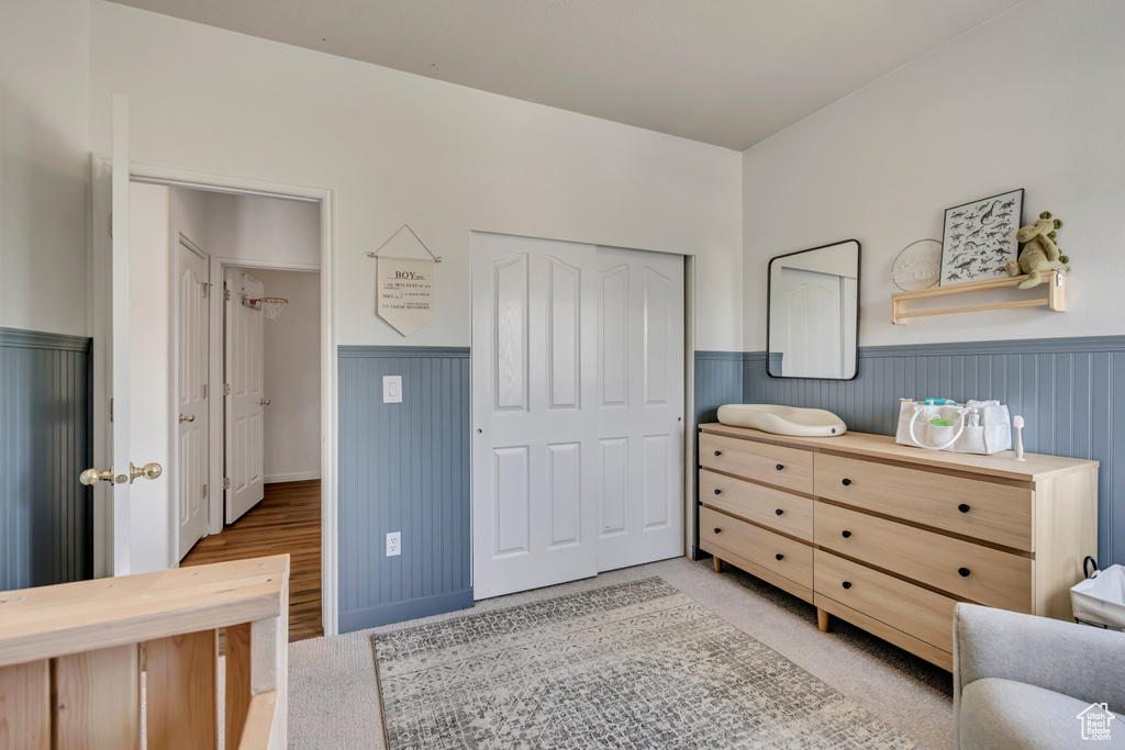 Bedroom with wainscoting and a closet