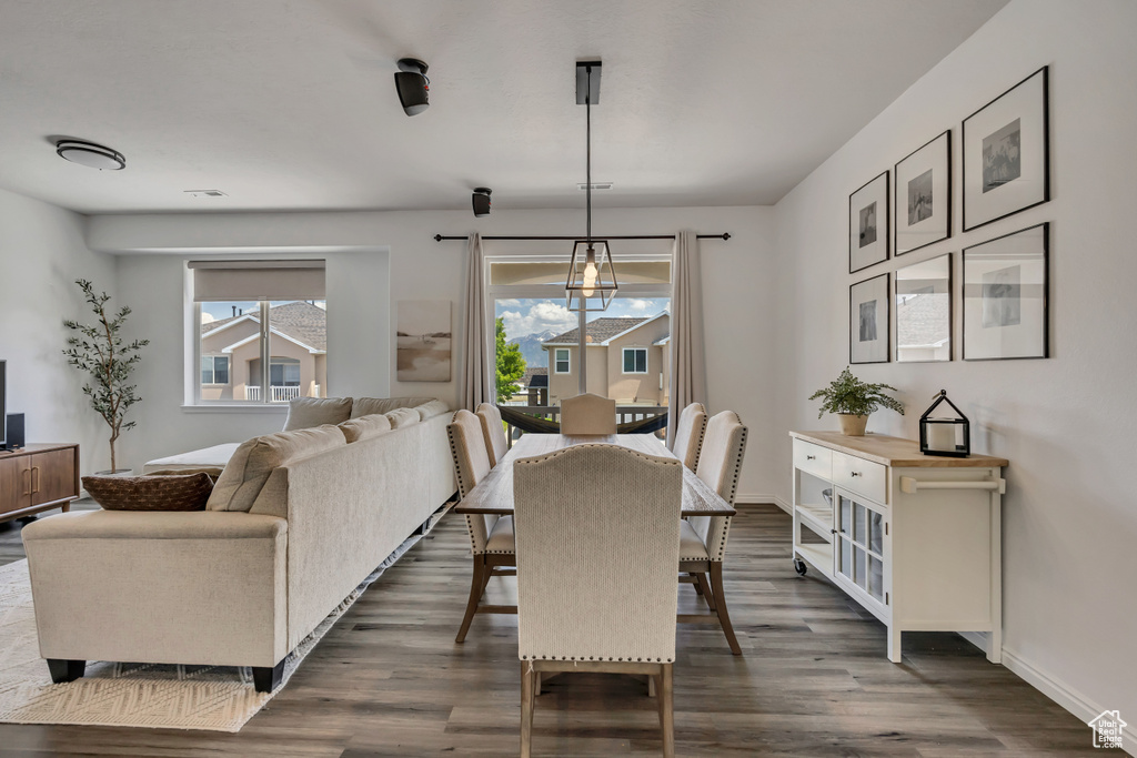 Dining space featuring dark wood-type flooring, plenty of natural light, and baseboards