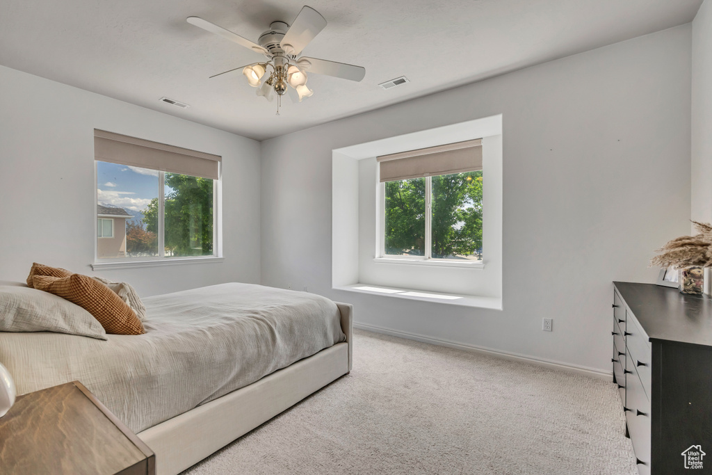 Bedroom with carpet floors, ceiling fan, and baseboards