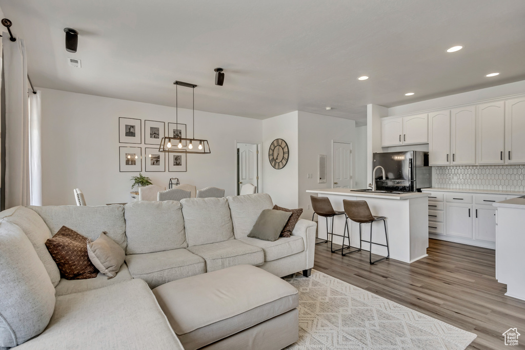 Living area with wood finished floors and recessed lighting