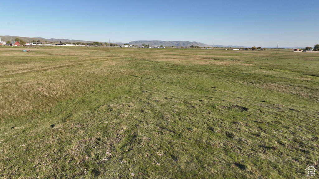 View of green lawn with a view of rural / pastoral area and a mountain view