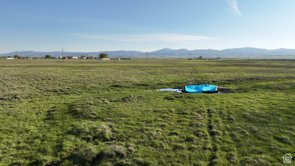 View of green lawn featuring a view of countryside and a mountain view
