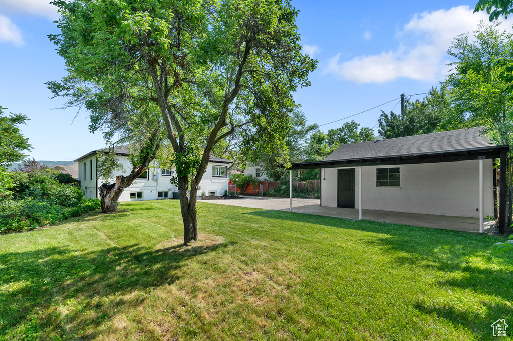 View of green lawn featuring a patio area