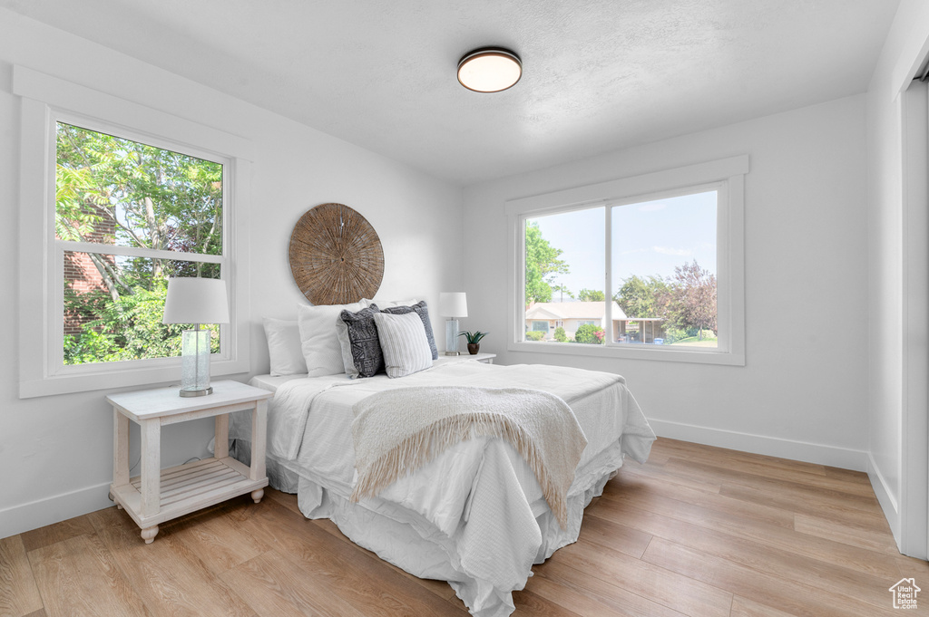 Bedroom featuring baseboards and light wood finished floors