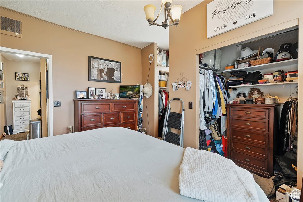 Bedroom with a chandelier and a closet