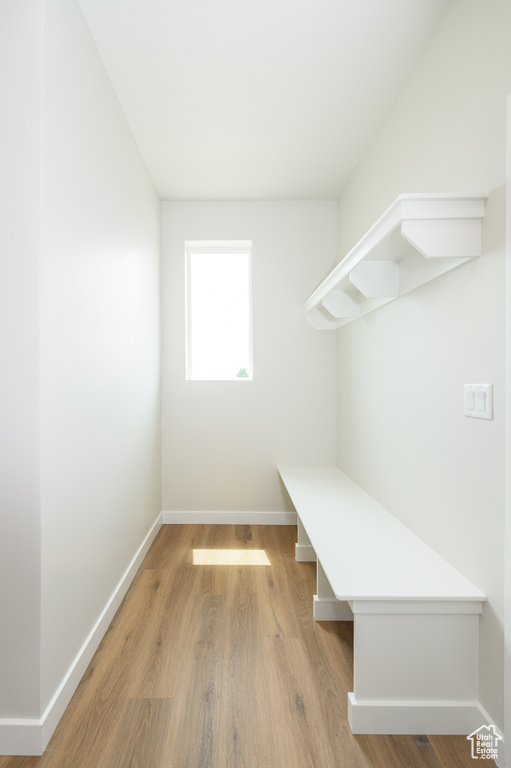 Mudroom with baseboards and light wood-style flooring