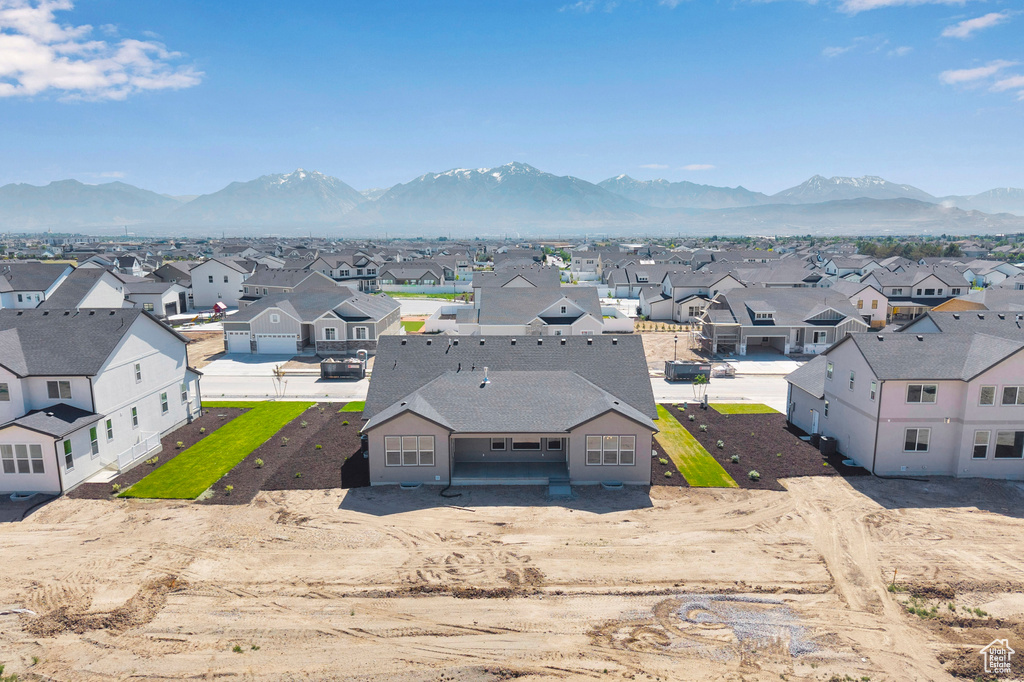 Aerial perspective of suburban area with a mountainous background