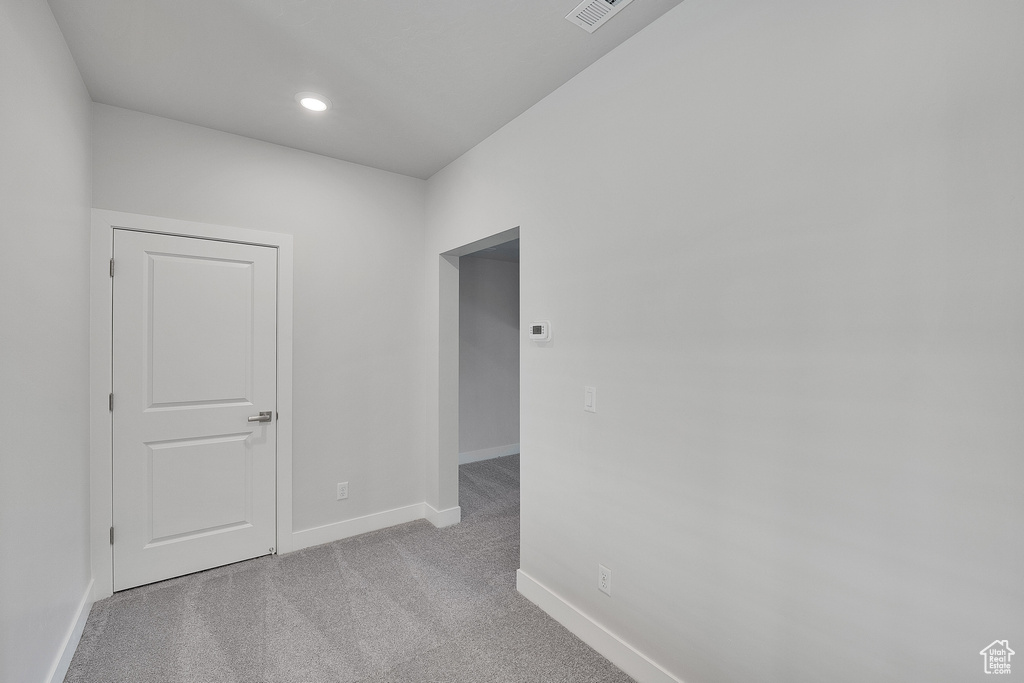 Spare room with baseboards, carpet floors, and recessed lighting