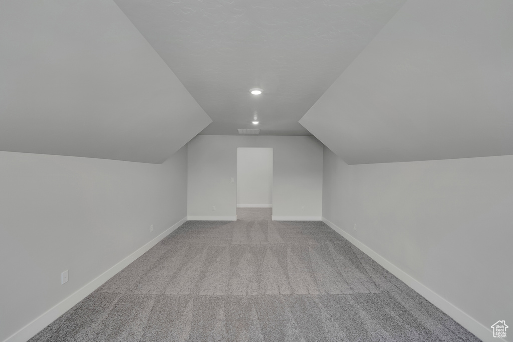 Bonus room featuring carpet flooring, vaulted ceiling, recessed lighting, and baseboards