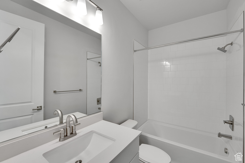 Bathroom with vanity, toilet, and shower / tub combination