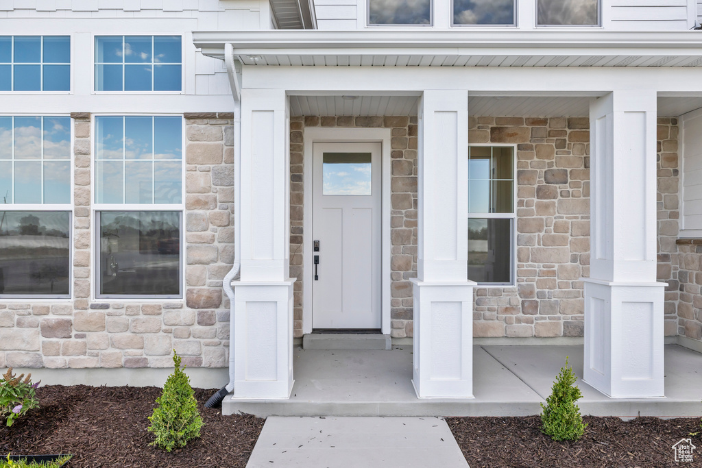 Entrance to property featuring stone siding