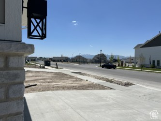 View of asphalt road with sidewalks and a mountain view