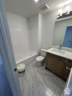 Full bathroom with vanity, toilet, shower / washtub combination, and marble finish floors