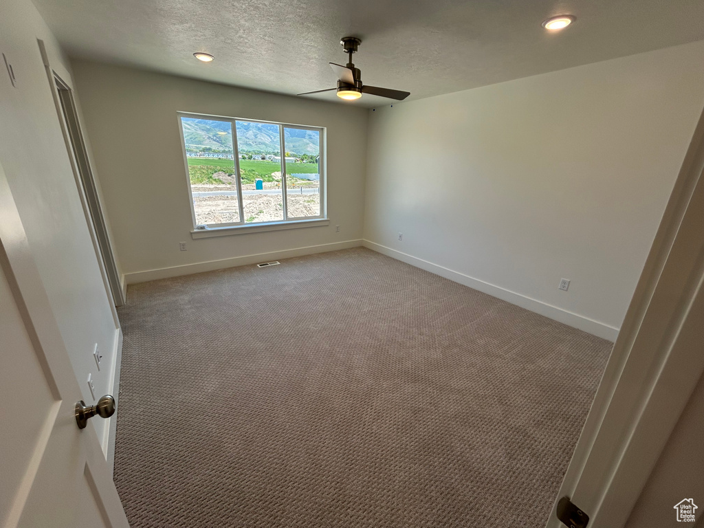 Unfurnished bedroom featuring baseboards, light colored carpet, recessed lighting, ceiling fan, and a textured ceiling