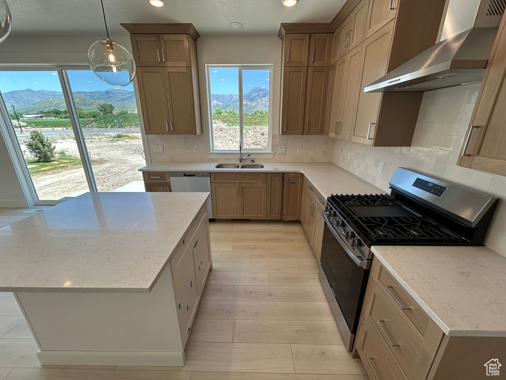 Kitchen with ventilation hood, stainless steel appliances, a sink, recessed lighting, and decorative backsplash