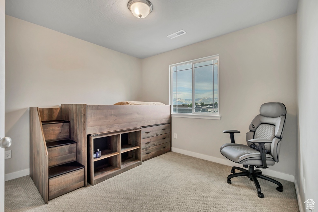 Bedroom featuring carpet and baseboards