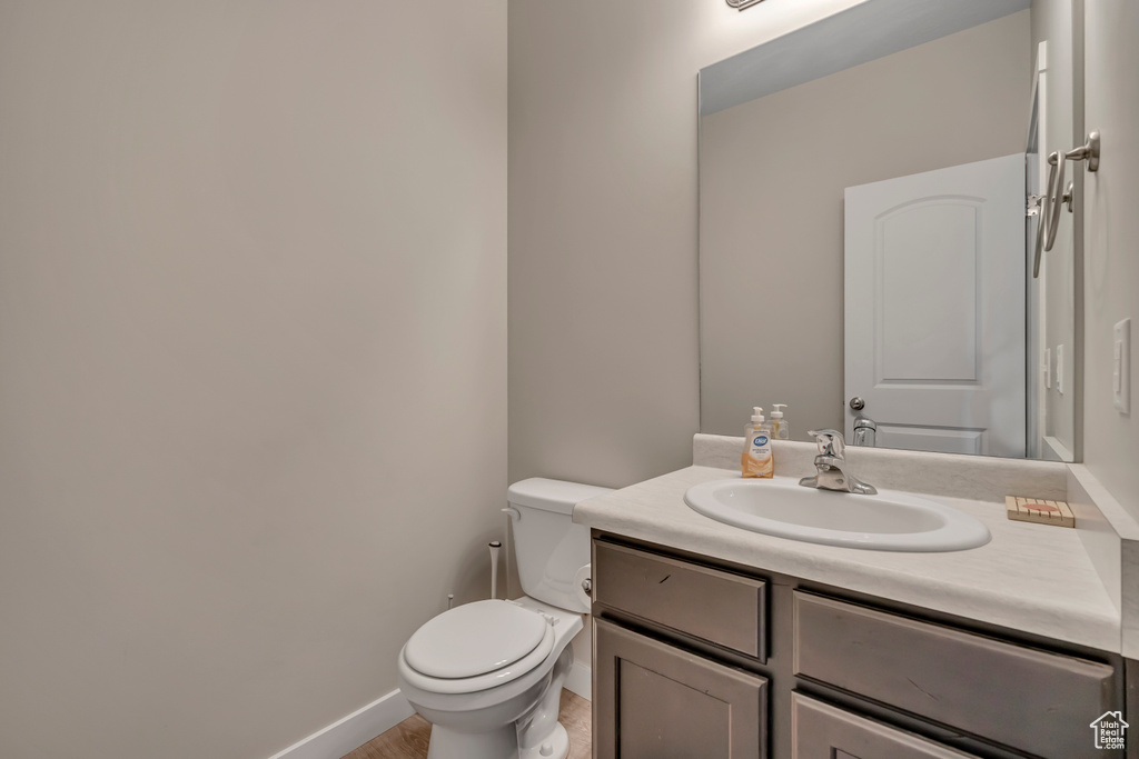 Half bathroom with vanity and toilet