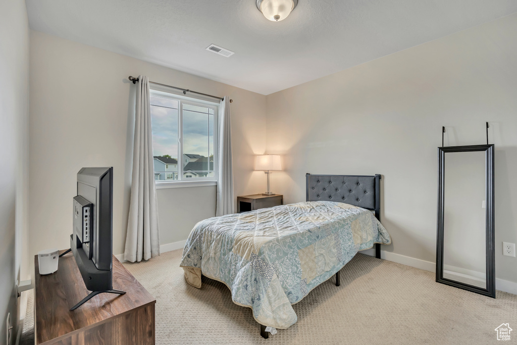 Bedroom with baseboards and carpet