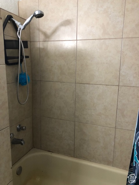 Bathroom featuring shower / bath combo with shower curtain