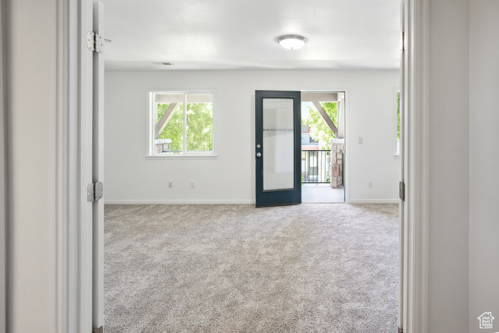 Spare room featuring carpet and baseboards