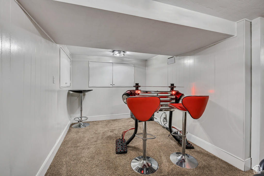 Workout area featuring carpet and baseboards