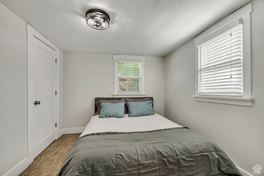 Bedroom with carpet flooring and baseboards