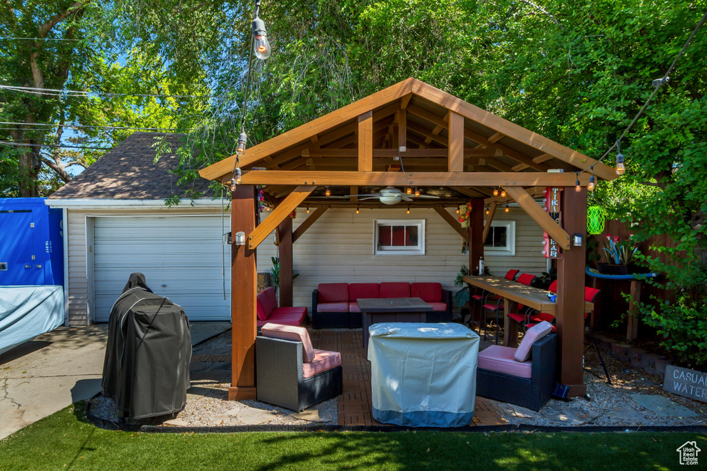 View of patio with an outdoor hangout area, grilling area, a garage, a gazebo, and driveway