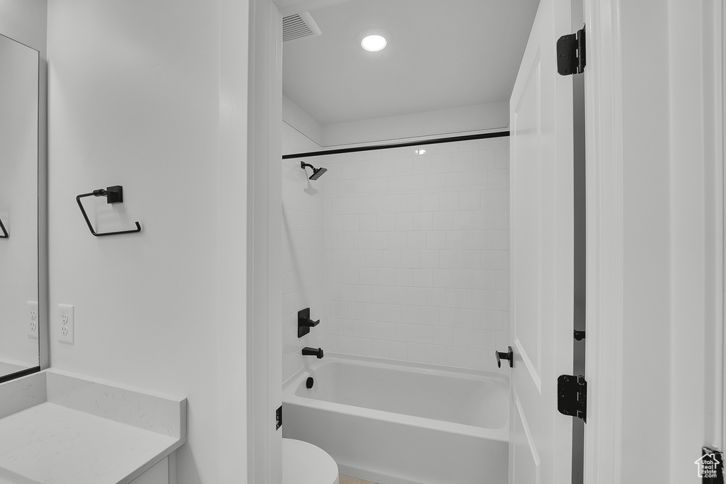 Full bath with tub / shower combination, toilet, vanity, and recessed lighting