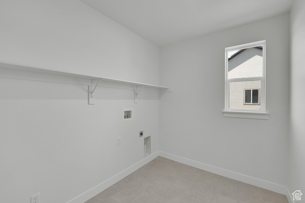 Laundry area featuring baseboards, washer hookup, and electric dryer hookup