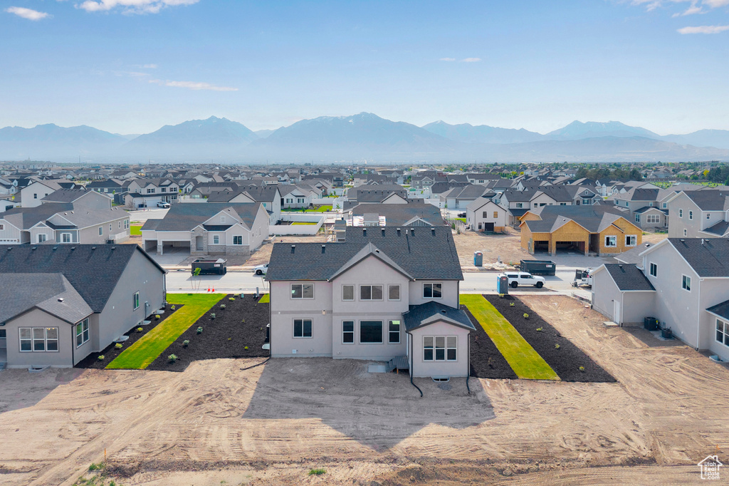 Aerial perspective of suburban area featuring a mountainous background