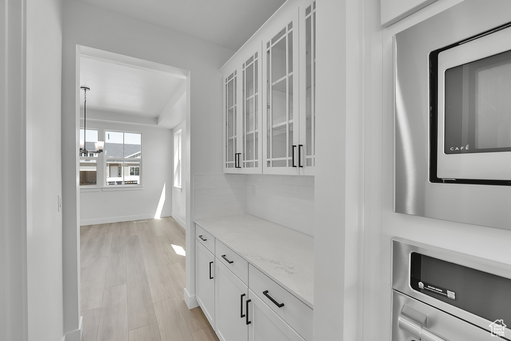 Hallway featuring baseboards and light wood-style floors