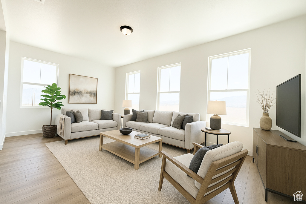 Living area featuring light wood-style flooring and baseboards