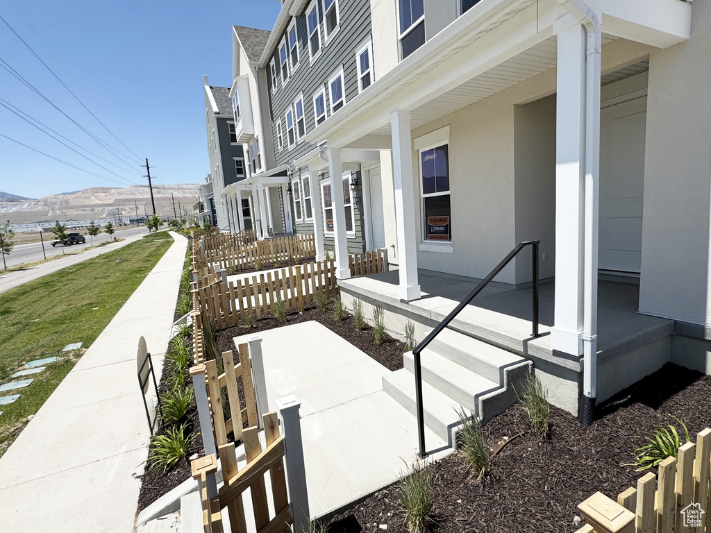 View of property exterior with a porch and stucco siding