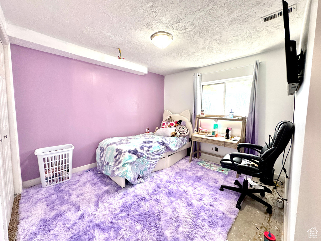 Bedroom featuring a textured ceiling