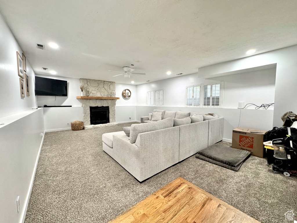 Living area with ceiling fan, carpet flooring, recessed lighting, a fireplace, and baseboards