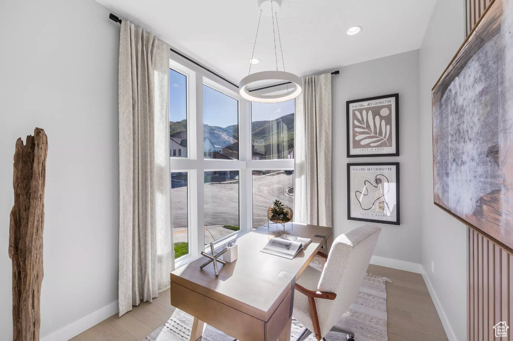 Office with light wood-style floors, baseboards, recessed lighting, and a mountain view