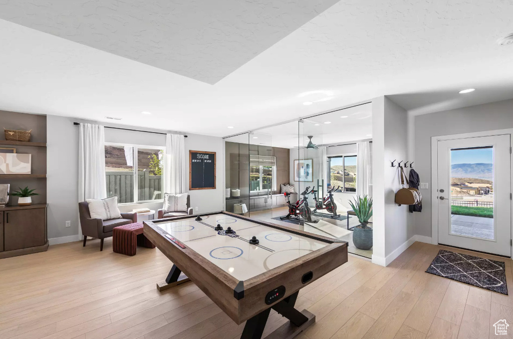 Game room with baseboards, light wood-style floors, and recessed lighting