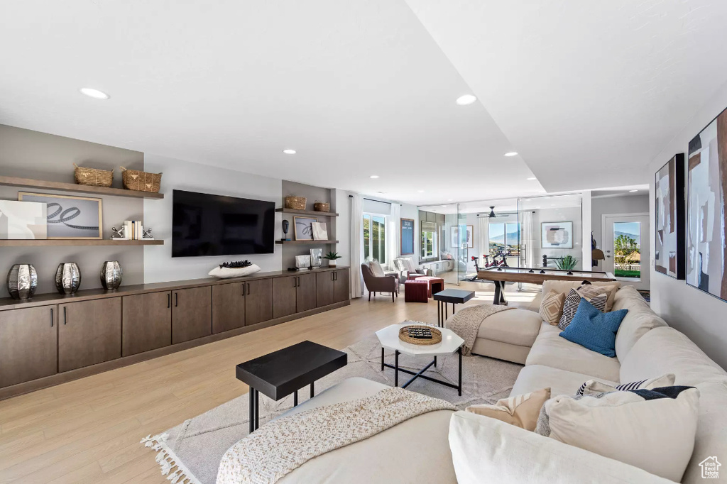 Living area featuring light wood finished floors and recessed lighting
