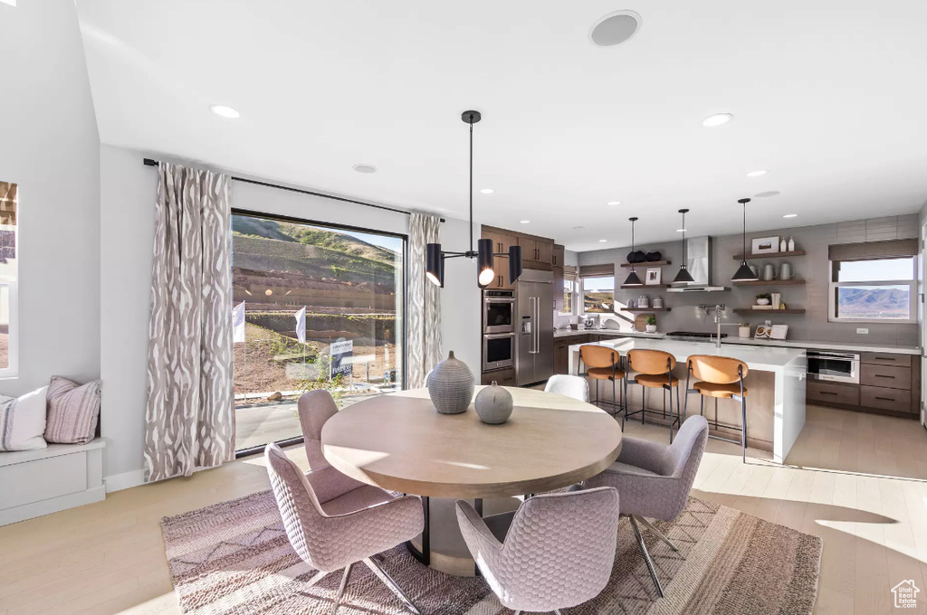 Dining area featuring light wood-style floors and recessed lighting