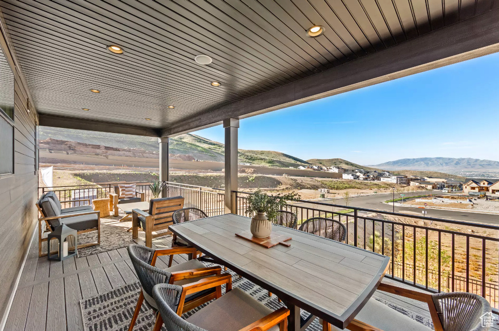 Wooden deck with a mountain view and outdoor dining area
