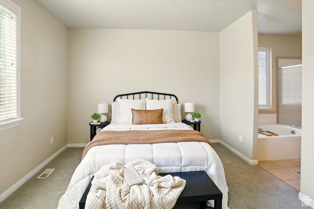 Carpeted bedroom featuring baseboards