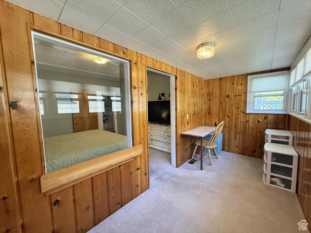 Bedroom with carpet floors and wood walls