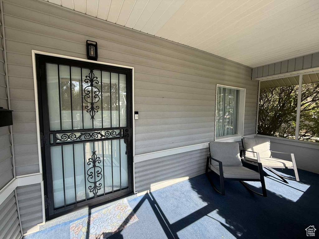View of exterior entry featuring covered porch