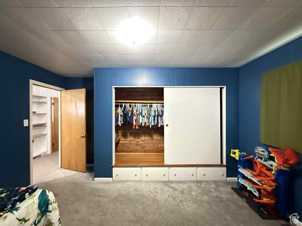 Carpeted bedroom with a closet