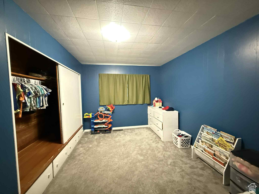 Carpeted bedroom featuring baseboards