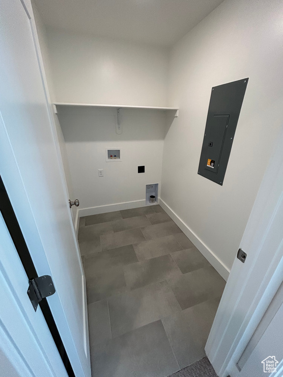 Laundry area featuring electric panel, washer hookup, and baseboards