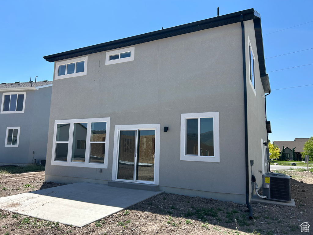 Back of house featuring a patio, central AC unit, and stucco siding