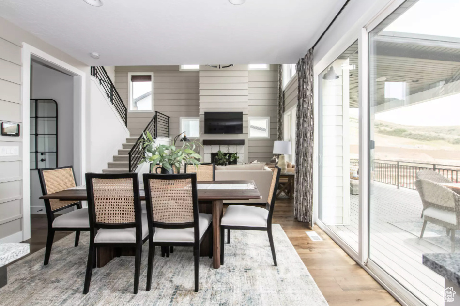 Dining space featuring light wood-type flooring and stairs