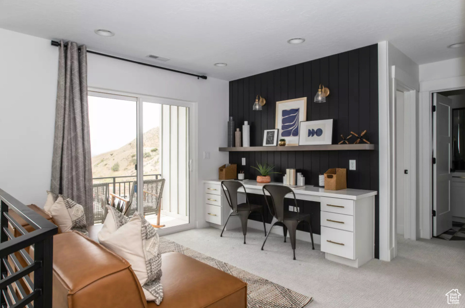 Office area with built in study area, light colored carpet, and recessed lighting